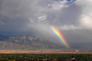Sandia mountains with clouds and rainbow