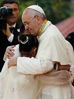 Pope Francis embraces a teenager